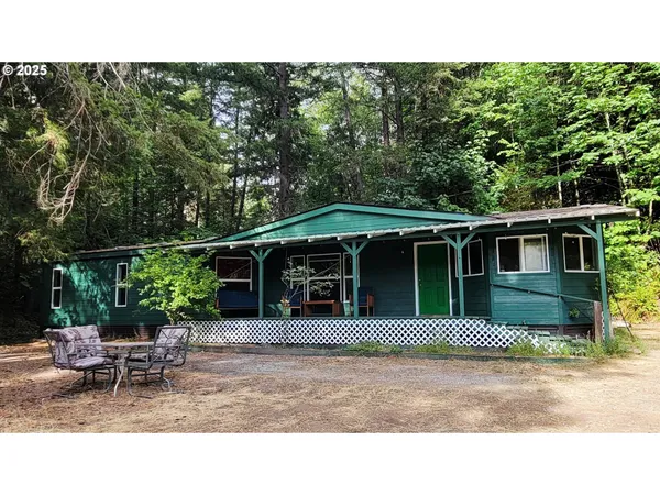 a house view with a sitting space and garden