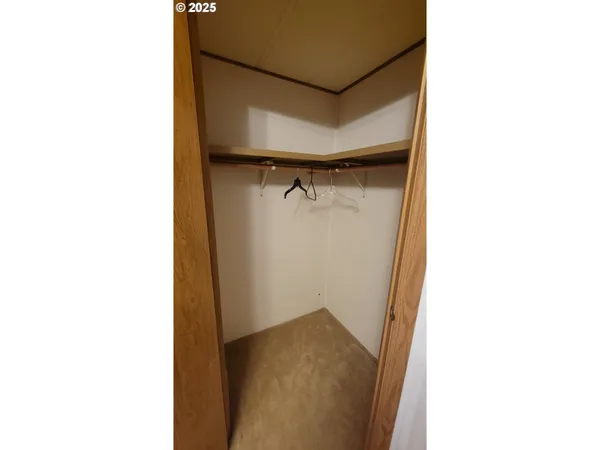 a open kitchen with furniture and a refrigerator