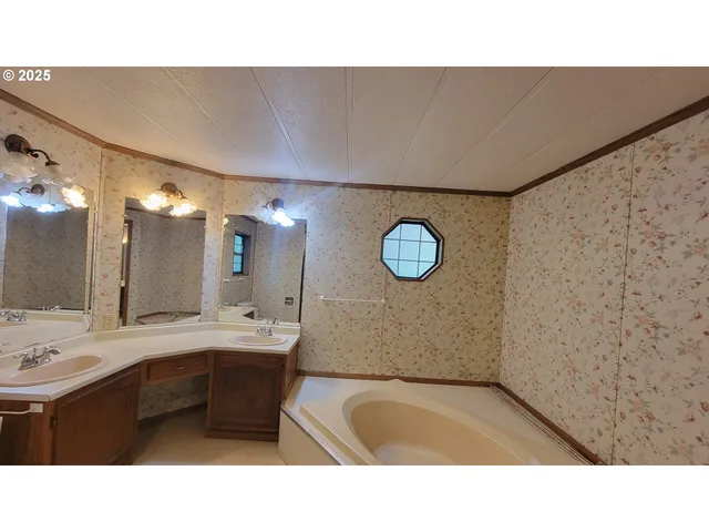 a bathroom with a tub sink and mirror