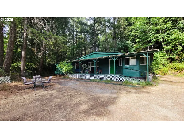 a backyard of a house with table and chairs