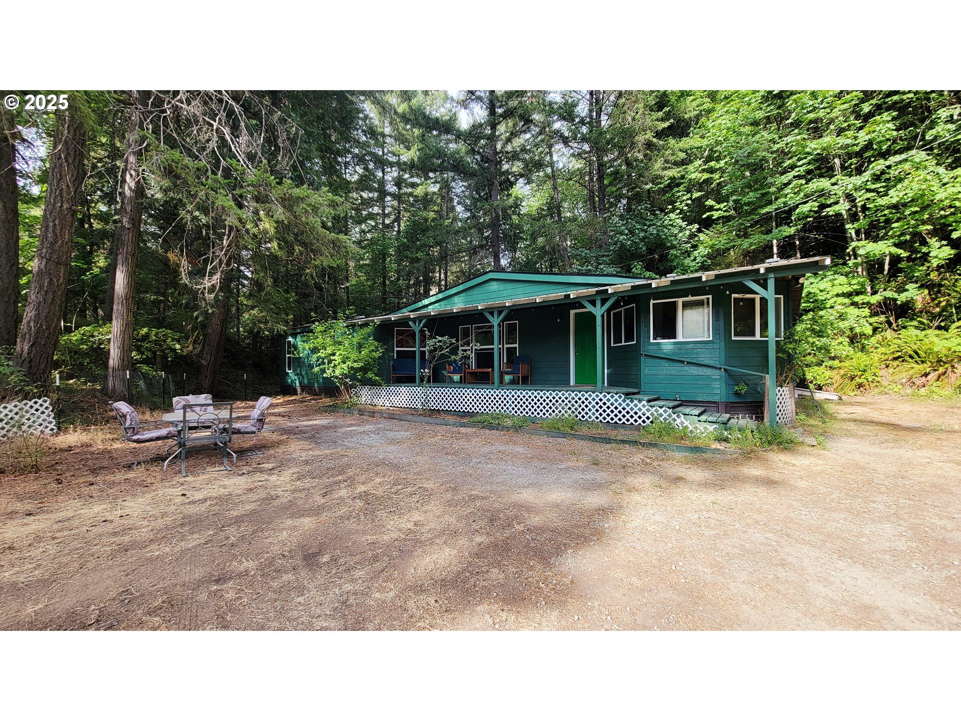 1097 Lees Creek Road Myrtle Creek, OR 97457 - Photo 6 of 41 a backyard of a house with table and chairs