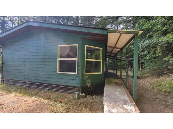 a backyard of a house with barbeque oven and outdoor seating space