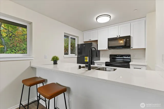 a view of a workspace with furniture and a flat screen tv