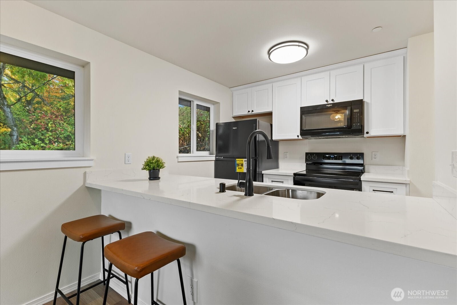 12600 57th Avenue South, Unit B201 Seattle, WA 98178 - Photo 11 of 24 a view of a workspace with furniture and a flat screen tv