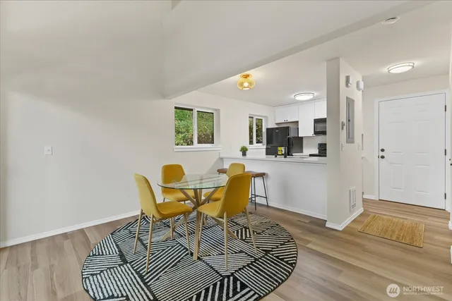 a view of a dining room with furniture and wooden floor