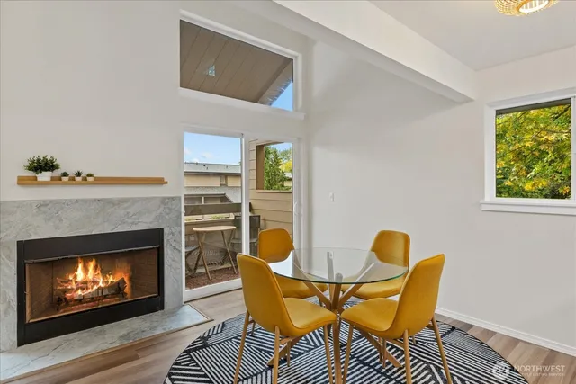 a living room with chairs and a fireplace