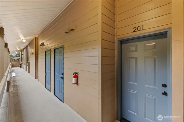 a view of a hallway with wooden walls