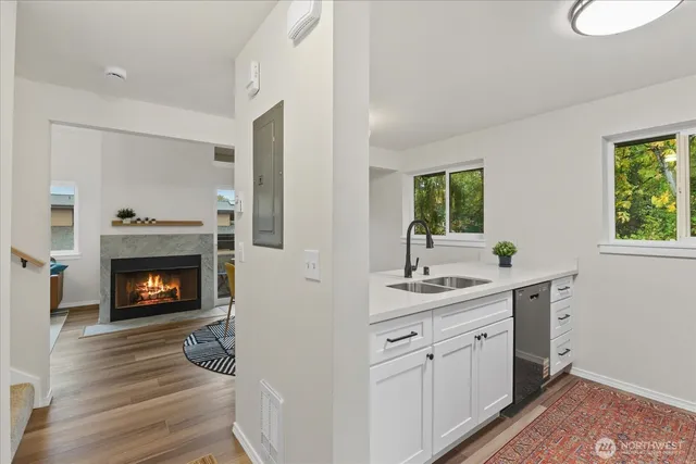 a kitchen with a sink and a fireplace