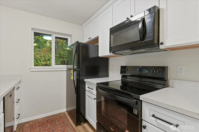 a kitchen with a stove microwave and refrigerator