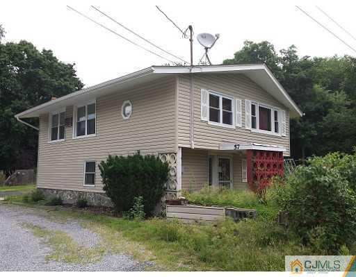 57 Driftway Road Howell, NJ 07731 - Photo 1 of 13 a front view of a house with garden