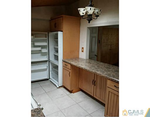 57 Driftway Road Howell, NJ 07731 - Photo 2 of 13 a kitchen with a cabinets and chandelier