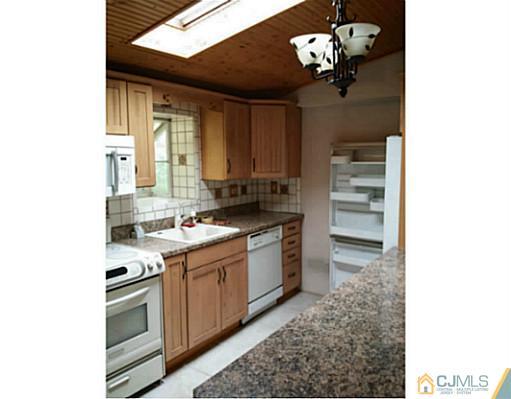 57 Driftway Road Howell, NJ 07731 - Photo 3 of 13 a kitchen with a sink cabinets and window