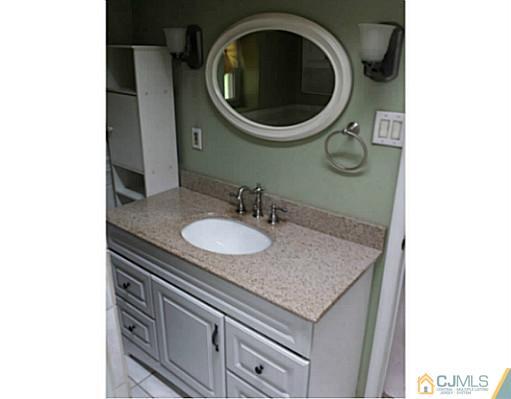 57 Driftway Road Howell, NJ 07731 - Photo 7 of 13 a bathroom with a granite countertop sink and a mirror