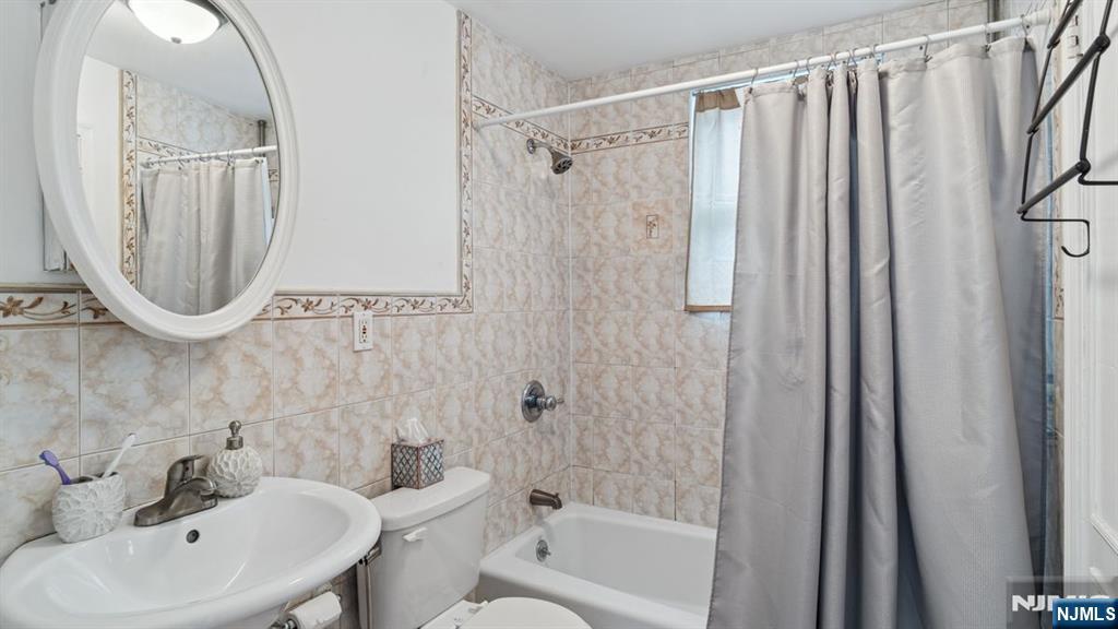 233 Lasalle Avenue Hasbrouck Heights, NJ 07604 - Photo 11 of 27 a bathroom with a sink a toilet and a mirror