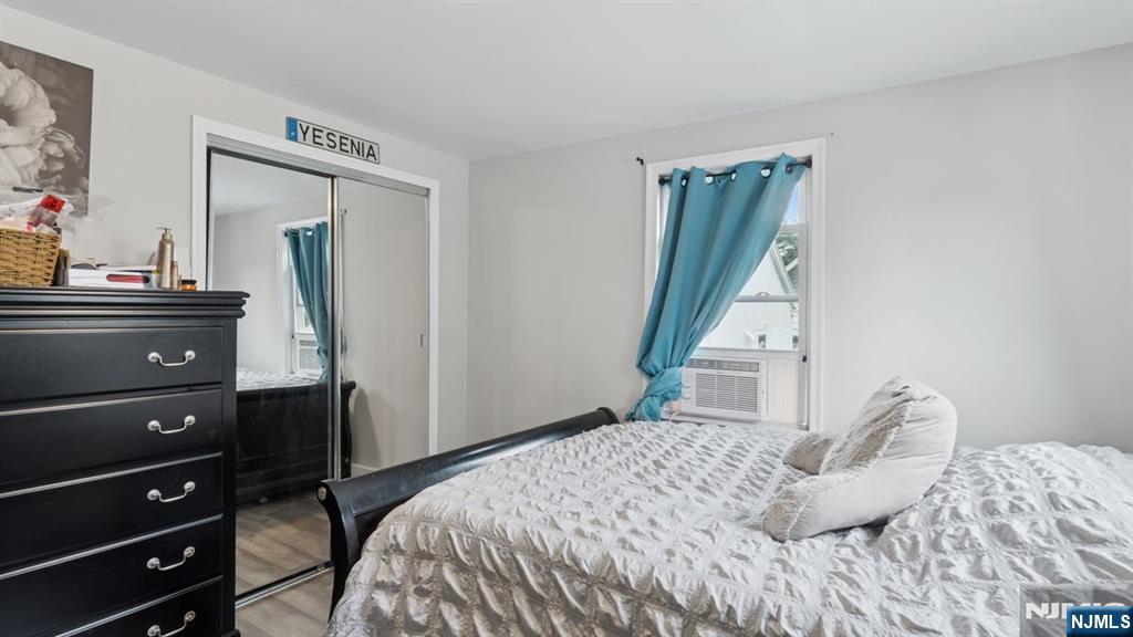 233 Lasalle Avenue Hasbrouck Heights, NJ 07604 - Photo 13 of 27 a bedroom with a bed a flat tv screen and a dresser