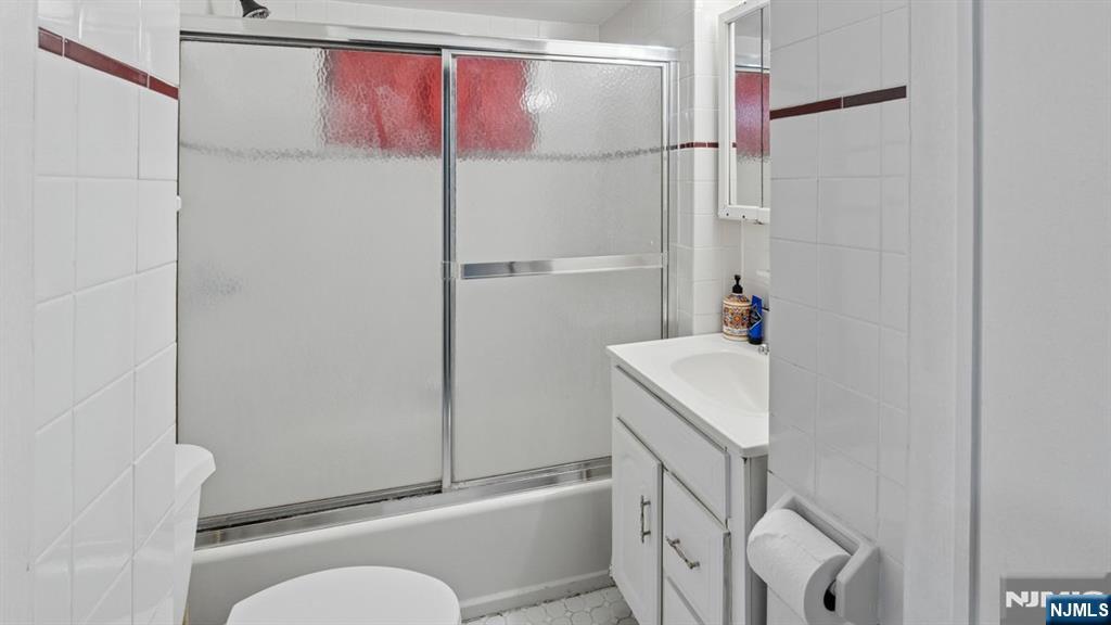 233 Lasalle Avenue Hasbrouck Heights, NJ 07604 - Photo 18 of 27 a bathroom with a granite countertop sink toilet and shower