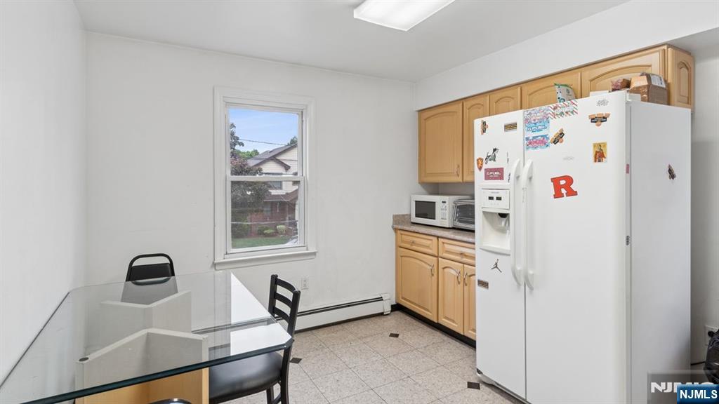 233 Lasalle Avenue Hasbrouck Heights, NJ 07604 - Photo 20 of 27 a kitchen with stainless steel appliances a refrigerator and a stove top oven