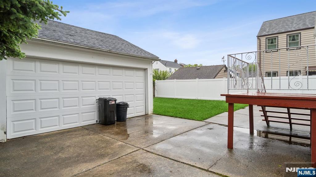 233 Lasalle Avenue Hasbrouck Heights, NJ 07604 - Photo 26 of 27 a view of a chair and table in the back yard of the house