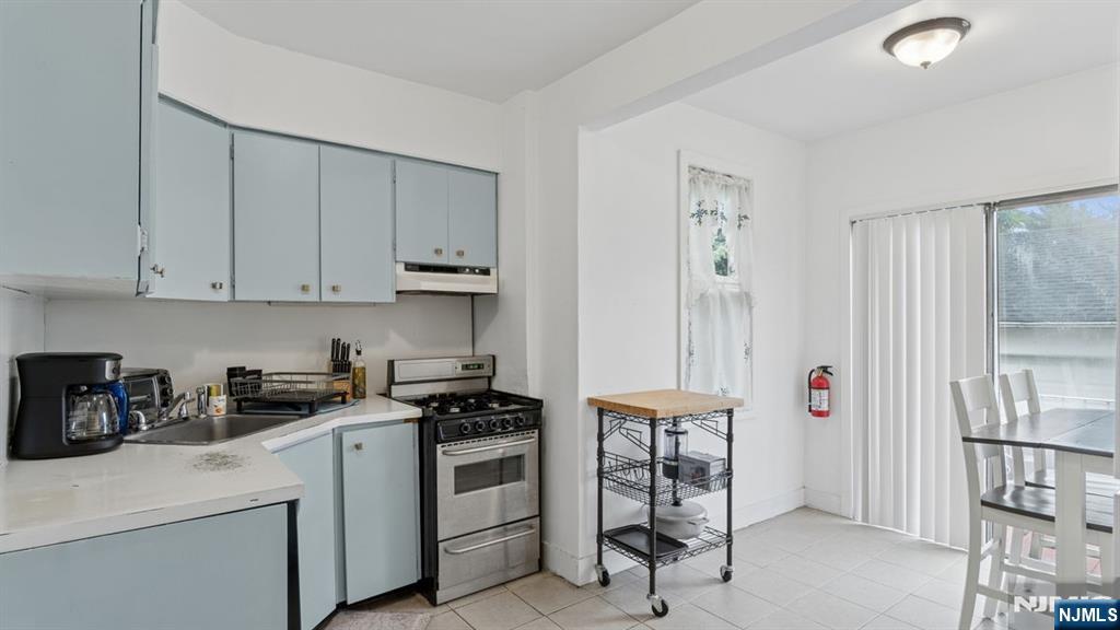 233 Lasalle Avenue Hasbrouck Heights, NJ 07604 - Photo 8 of 27 a kitchen with cabinets and appliances