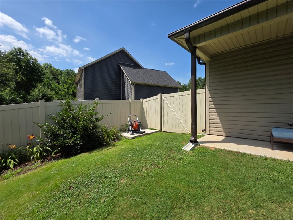 3 Cringle Lane Anderson, SC 29625 - Photo 19 of 26 A neatly fenced yard offers private green space, bordered by mature landscaping and a well-maintained exterior.