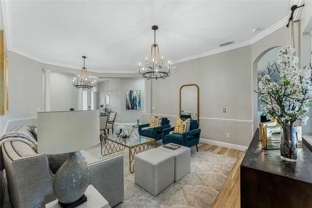 a living room with furniture and a chandelier
