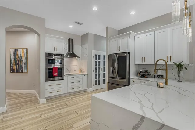 a kitchen with stainless steel appliances a refrigerator sink and cabinets