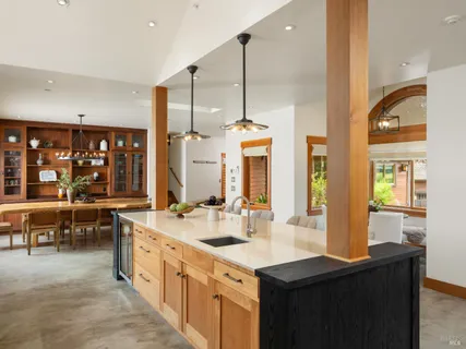 a kitchen with stainless steel appliances a sink stove and cabinets