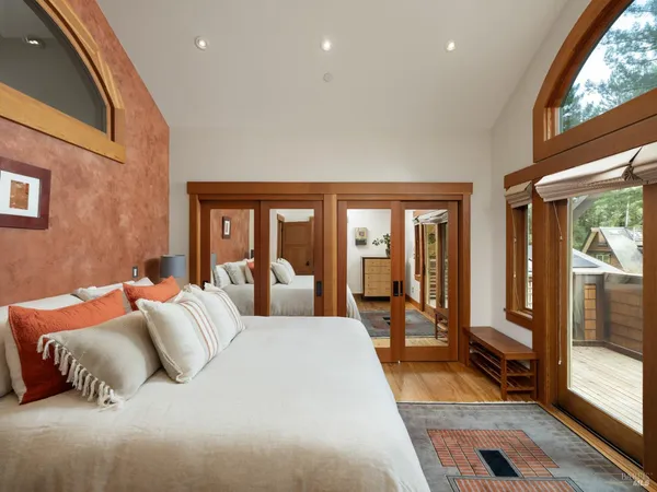 a spacious bedroom with a large bed and a large window