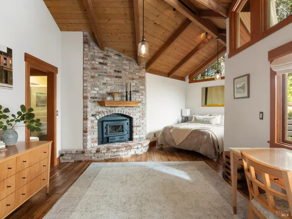 a spacious bedroom with a bed and a fireplace