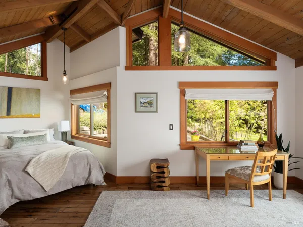 a bedroom with a bed and a table