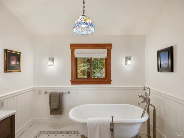 a white bath tub sitting next to a small bathroom