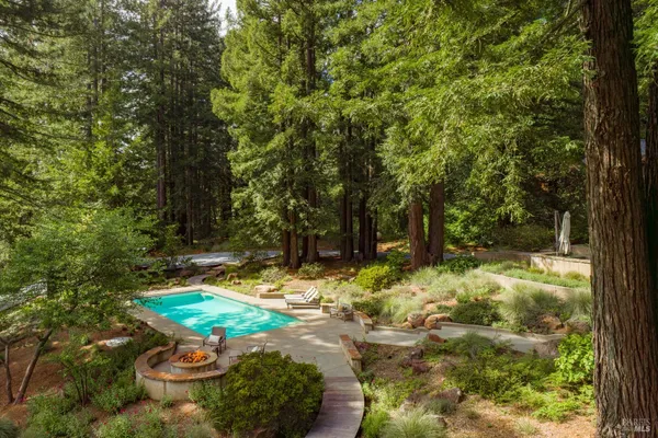 a backyard of a house with yard and outdoor seating
