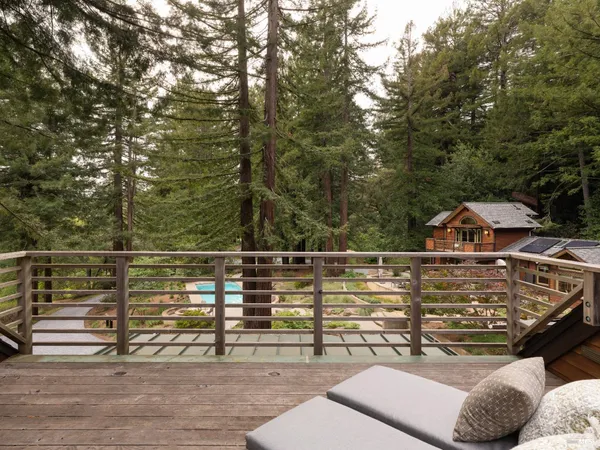 a front view of a building with large trees