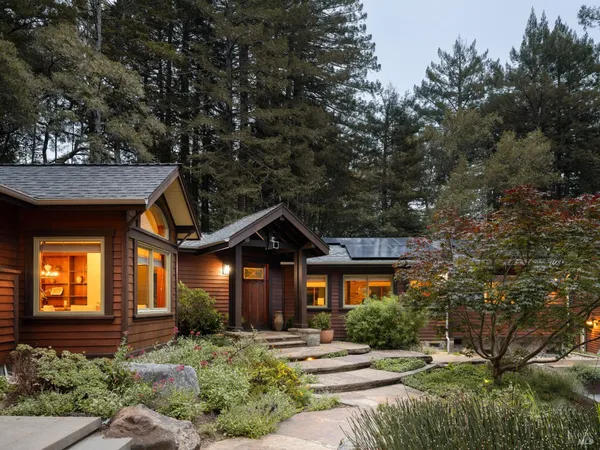 a view of a patio with couches table and chairs and potted plants