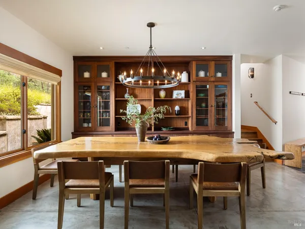 a dining room with furniture window and wooden floor