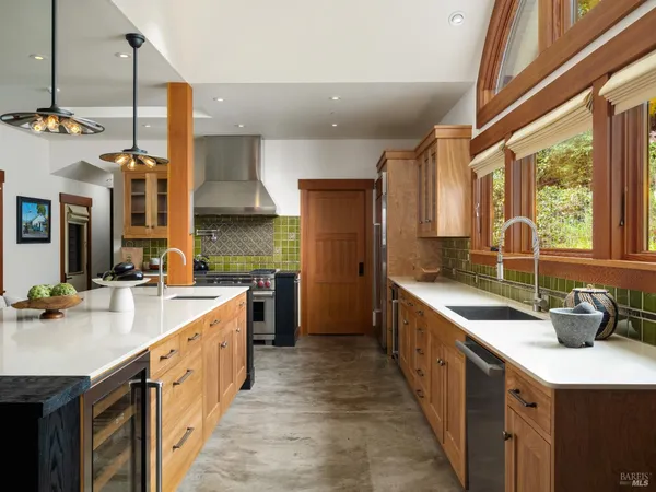 a kitchen with stainless steel appliances a sink stove and cabinets