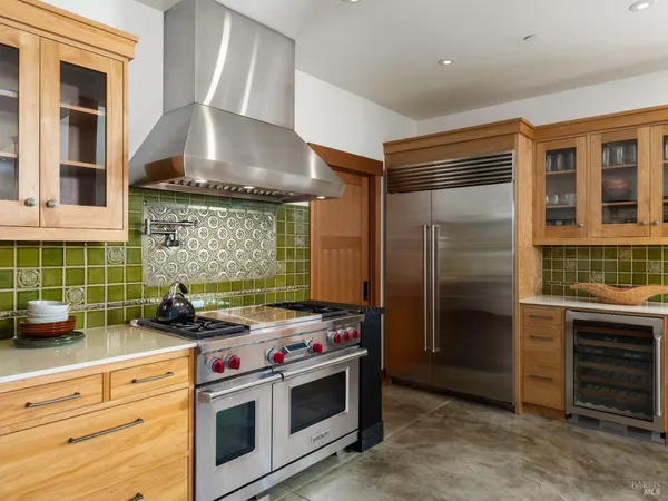 a kitchen with stainless steel appliances a stove and a refrigerator
