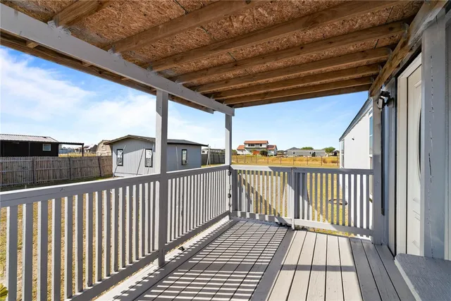 a view of balcony with wooden floor