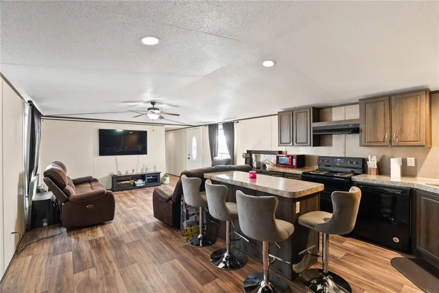 a kitchen with granite countertop a sink dining table and chairs