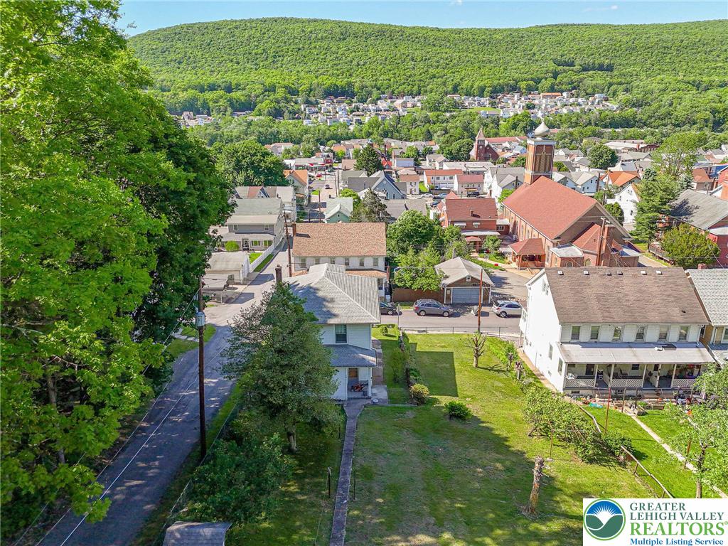 159 West Ridge Street Nesquehoning, PA 18240 - Photo 49 of 55 An aerial perspective reveals a charming town nestled among verdant hillsides, offering peaceful community living.