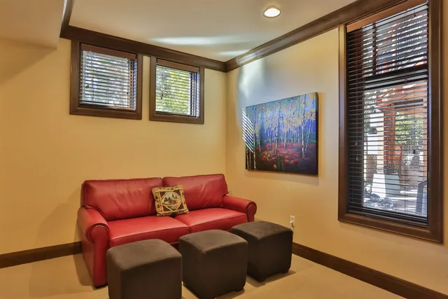 a blue couch sitting in a living room next to a window