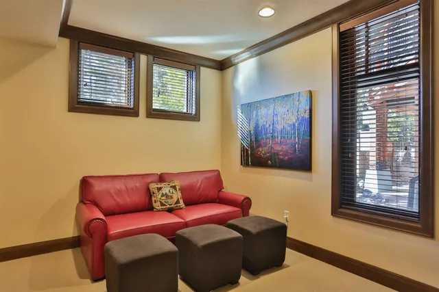 a blue couch sitting in a living room next to a window