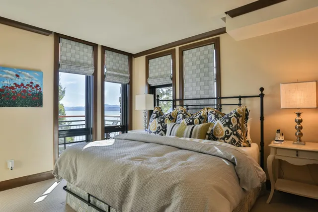 a bed sitting in a bedroom next to a window