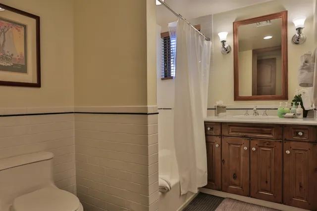 a bathroom with a granite countertop sink toilet and shower