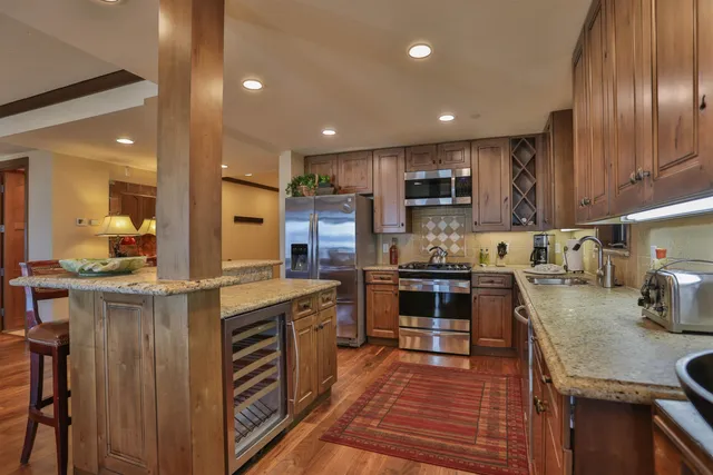 a kitchen with a sink stainless steel appliances and cabinets