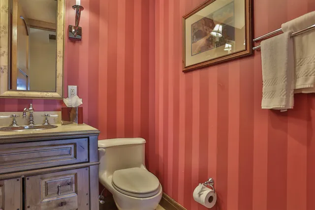 a bathroom with a toilet a sink and curtain