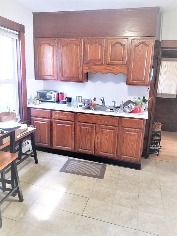 12 Linden Circle Somerville, MA 02143 - Photo 11 of 24 a kitchen with granite countertop a sink and cabinets