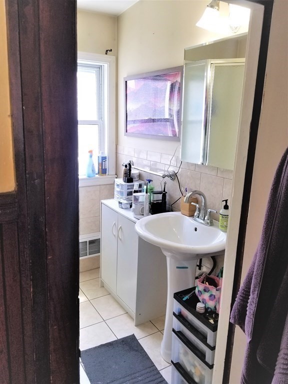 12 Linden Circle Somerville, MA 02143 - Photo 16 of 24 a bathroom with a sink and a mirror