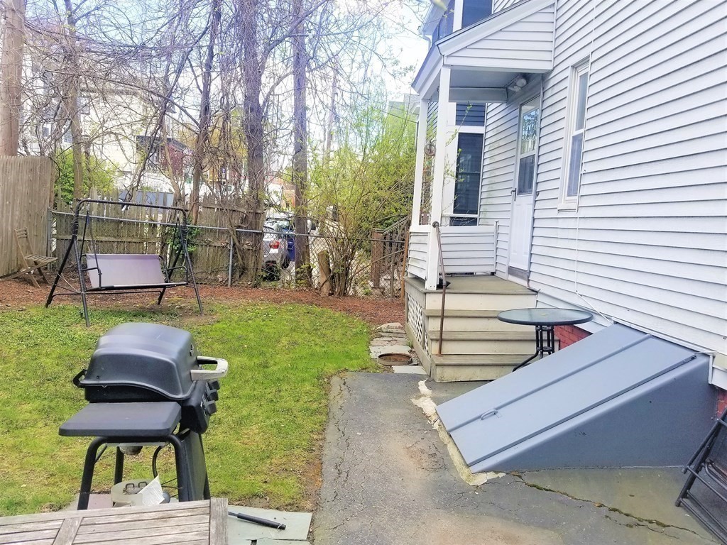 12 Linden Circle Somerville, MA 02143 - Photo 23 of 24 a backyard of a house with table and chairs