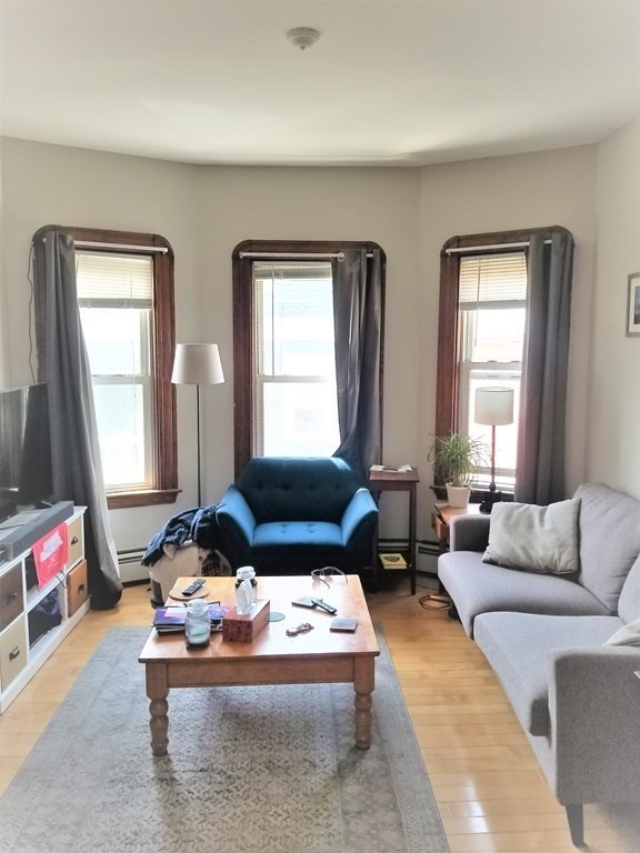 12 Linden Circle Somerville, MA 02143 - Photo 10 of 24 a living room with furniture and a large window